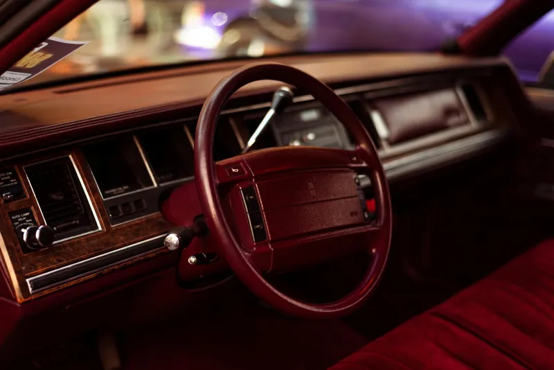 Burgundy Velour and Wood Grain Dreams: When Car Interiors Were Personal Statements, Not Corporate Compromises